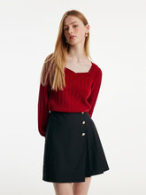 A lady wears a red sweater on Thanksgiving day.